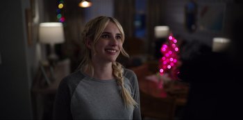 Movie still from “About Fate” (2022), directed by Marius Vaysberg – A woman with blonde hair is standing in a living room; Close Up shot, Over the shoulder angle