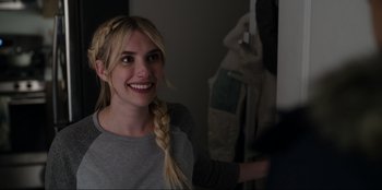 Movie still from “About Fate” (2022), directed by Marius Vaysberg – A woman with long blonde hair smiles at the camera; Close Up shot, Over the shoulder angle