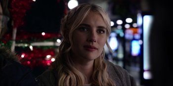 Movie still from “About Fate” (2022), directed by Marius Vaysberg – A woman with blonde hair is looking at the camera; Close Up shot, Over the shoulder angle