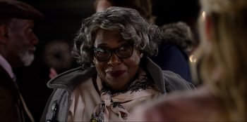 Movie still from “About Fate” (2022), directed by Marius Vaysberg – A person wearing glasses and a wig; Close Up shot, Over the shoulder angle