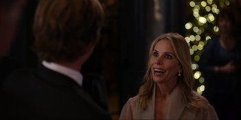 Movie still from “About Fate” (2022), directed by Marius Vaysberg – A woman smiles at a man in a suit and tie; Close Up shot, Over the shoulder angle
