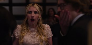 Movie still from “About Fate” (2022), directed by Marius Vaysberg – A woman in a white dress is looking surprised; Close Up shot, Over the shoulder angle