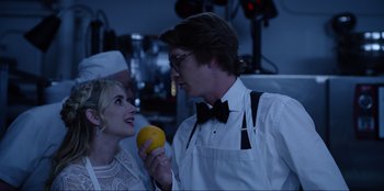 Movie still from “About Fate” (2022), directed by Marius Vaysberg – A man and a woman holding an orange in their hands; Close Up shot, Over the shoulder angle