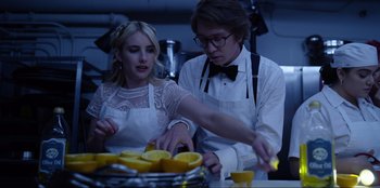 Movie still from “About Fate” (2022), directed by Marius Vaysberg – A man and a woman cutting oranges in a kitchen; Medium shot, Low angle