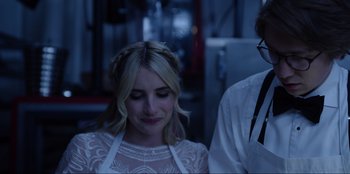 Movie still from “About Fate” (2022), directed by Marius Vaysberg – A woman in a white dress is standing next to a man in a white shirt; Close Up shot, Over the shoulder angle