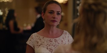 Movie still from “About Fate” (2022), directed by Marius Vaysberg – A woman in a white dress looking at the camera; Close Up shot, Over the shoulder angle