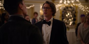 Movie still from “About Fate” (2022), directed by Marius Vaysberg – A man in a tuxedo talking to another man in a suit; Close Up shot, Over the shoulder angle