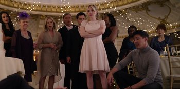 Movie still from “About Fate” (2022), directed by Marius Vaysberg – A woman standing in front of a group of people; Medium shot, Over the shoulder angle