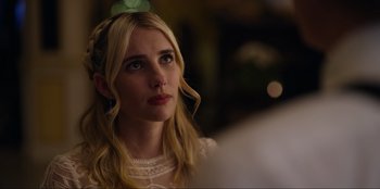 Movie still from “About Fate” (2022), directed by Marius Vaysberg – A beautiful young lady with long blonde hair and blue eyes; Close Up shot, Over the shoulder angle