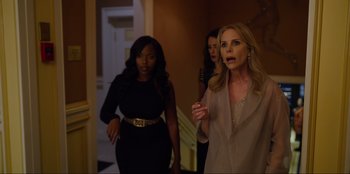 Movie still from “About Fate” (2022), directed by Marius Vaysberg – A group of women walking down the hall way; Medium shot, Over the shoulder angle