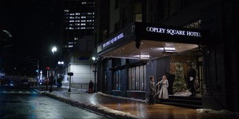 Movie still from “About Fate” (2022), directed by Marius Vaysberg – A couple of people that are standing in front of a building; Extreme Wide shot, Over the shoulder angle