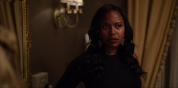 Movie still from “About Fate” (2022), directed by Marius Vaysberg – A woman in a black shirt is standing in a room; Close Up shot, Over the shoulder angle