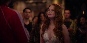 Movie still from “About Fate” (2022), directed by Marius Vaysberg – A woman with long red hair is looking up; Close Up shot, Over the shoulder angle