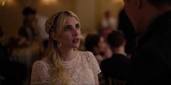 Movie still from “About Fate” (2022), directed by Marius Vaysberg – A woman in a white dress is looking up at something; Close Up shot, Over the shoulder angle