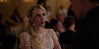 Movie still from “About Fate” (2022), directed by Marius Vaysberg – A woman in a white dress looking to her left; Close Up shot, Over the shoulder angle