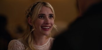 Movie still from “About Fate” (2022), directed by Marius Vaysberg – A woman smiling and looking to her left; Close Up shot, Over the shoulder angle