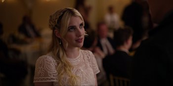 Movie still from “About Fate” (2022), directed by Marius Vaysberg – A woman in a white dress is sitting in a room; Close Up shot, Over the shoulder angle