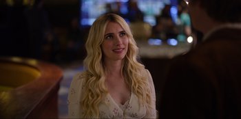 Movie still from “About Fate” (2022), directed by Marius Vaysberg – A woman with long blonde hair wearing a white dress; Close Up shot, Over the shoulder angle