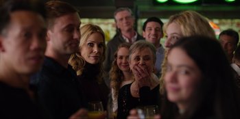 Movie still from “About Fate” (2022), directed by Marius Vaysberg – A group of people standing around a table with wine glasses; Close Up shot, Over the shoulder angle