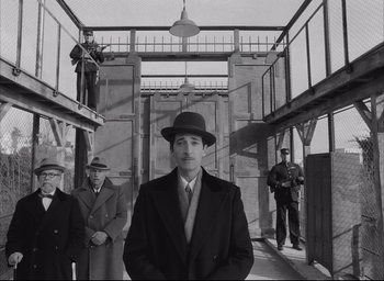 Movie still from “The French Dispatch” (2021), directed by Wes Anderson – Medium shot, Low angle