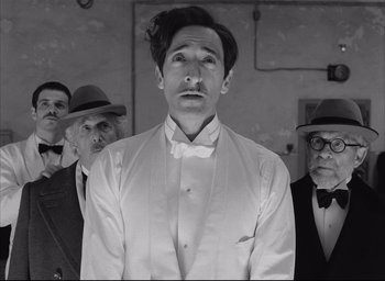 Movie still from “The French Dispatch” (2021), directed by Wes Anderson – Medium shot, Low angle