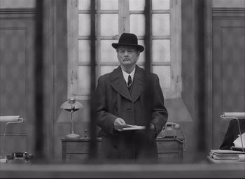 Movie still from “The French Dispatch” (2021), directed by Wes Anderson – Medium shot, Low angle