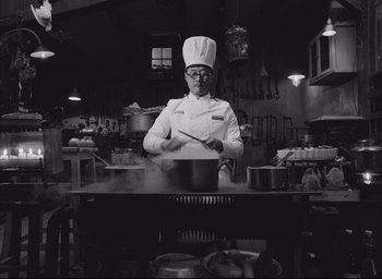 Movie still from “The French Dispatch” (2021), directed by Wes Anderson – Medium shot, Low angle