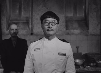 Movie still from “The French Dispatch” (2021), directed by Wes Anderson – Close Up shot, Over the shoulder angle