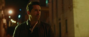 Movie still from “Accident Man: Hitman's Holiday” (2022), directed by George Kirby – A person wearing a jacket; Close Up shot, Over the shoulder angle