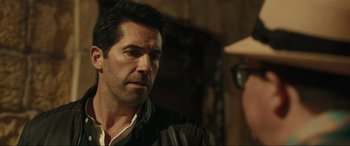 Movie still from “Accident Man: Hitman's Holiday” (2022), directed by George Kirby – A person wearing a jacket; Close Up shot, Over the shoulder angle