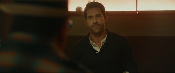 Movie still from “Accident Man: Hitman's Holiday” (2022), directed by George Kirby – A person looking at a mirror; Close Up shot, Over the shoulder angle