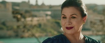 Movie still from “Accident Man: Hitman's Holiday” (2022), directed by George Kirby – A person wearing a blue shirt; Close Up shot, Over the shoulder angle