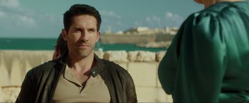 Movie still from “Accident Man: Hitman's Holiday” (2022), directed by George Kirby – A person wearing a leather jacket; Close Up shot, Over the shoulder angle