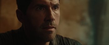 Movie still from “Accident Man: Hitman's Holiday” (2022), directed by George Kirby – A man's face looking into the distance; Close Up shot, Over the shoulder angle