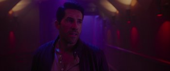 Movie still from “Accident Man: Hitman's Holiday” (2022), directed by George Kirby – A person wearing a leather jacket; Close Up shot, Over the shoulder angle