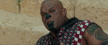 Movie still from “Accident Man: Hitman's Holiday” (2022), directed by George Kirby – A man with a face paint on his face; Close Up shot, High angle