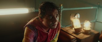 Movie still from “Accident Man: Hitman's Holiday” (2022), directed by George Kirby – A person wearing a towel; Medium shot, Low angle