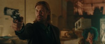 Movie still from “Accident Man: Hitman's Holiday” (2022), directed by George Kirby – A person with long hair; Close Up shot, Over the shoulder angle