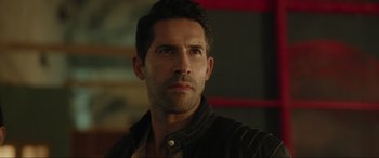 Movie still from “Accident Man: Hitman's Holiday” (2022), directed by George Kirby – A person wearing a jacket; Close Up shot, Over the shoulder angle