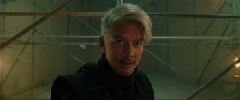 Movie still from “Accident Man: Hitman's Holiday” (2022), directed by George Kirby – A man with white hair is posing for a picture; Close Up shot, Low angle