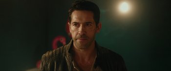 Movie still from “Accident Man: Hitman's Holiday” (2022), directed by George Kirby – A person wearing a leather jacket; Close Up shot, Over the shoulder angle