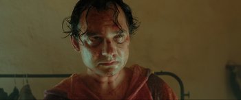 Movie still from “Accident Man: Hitman's Holiday” (2022), directed by George Kirby – A person with blood all over his face; Close Up shot, Low angle