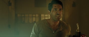 Movie still from “Accident Man: Hitman's Holiday” (2022), directed by George Kirby – A person with a bruise on his face; Close Up shot, Over the shoulder angle