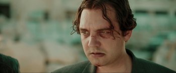 Movie still from “Accident Man: Hitman's Holiday” (2022), directed by George Kirby – A person looking at the camera; Close Up shot, Low angle