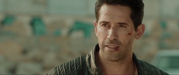 Movie still from “Accident Man: Hitman's Holiday” (2022), directed by George Kirby – A person wearing a leather jacket; Close Up shot, Over the shoulder angle