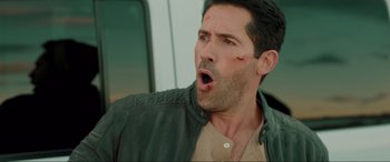 Movie still from “Accident Man: Hitman's Holiday” (2022), directed by George Kirby – A person wearing a jacket; Close Up shot, Over the shoulder angle