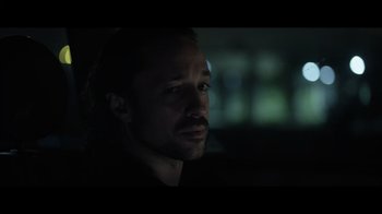 Movie still from “Adverse” (2020), directed by Brian A. Metcalf – A person in a dark room; Close Up shot, Low angle