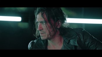 Movie still from “Adverse” (2020), directed by Brian A. Metcalf – A person wearing a leather jacket; Close Up shot, Low angle