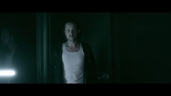Movie still from “Adverse” (2020), directed by Brian A. Metcalf – A man in a white shirt and a black jacket; Medium shot, Low angle