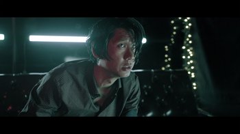 Movie still from “Adverse” (2020), directed by Brian A. Metcalf – A man sitting in a chair in front of lights; Close Up shot, Low angle